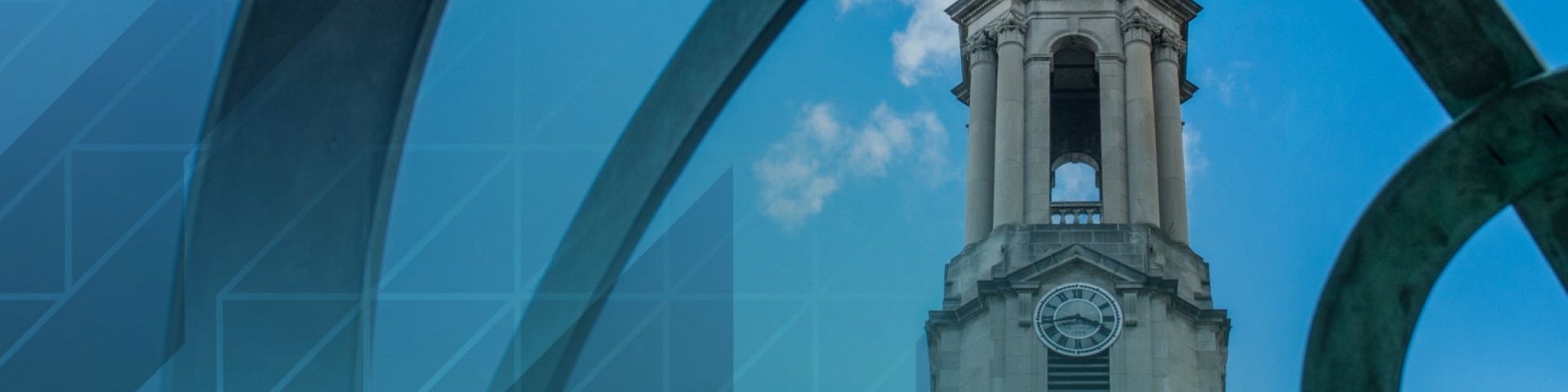 Old Main cupola viewed through metal sculpture with geometric design overlay.